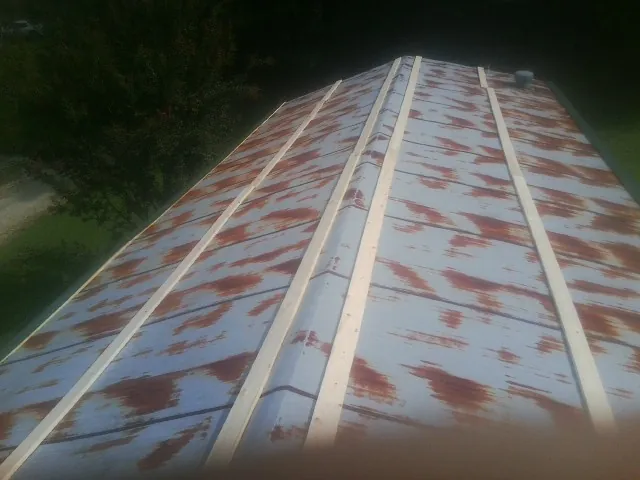 Rusted metal roof panels with new wood purlins before replacement — Storm Damage Roof Repair in Landisville by Roofing Brothers